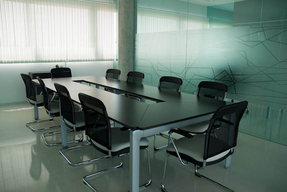 Elegant conference room with sleek black chairs and a modern glass wall design