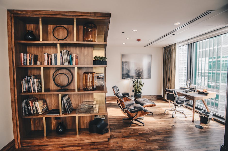 Stylish office space featuring a wooden bookshelf and a minimalist desk setup, ideal for work